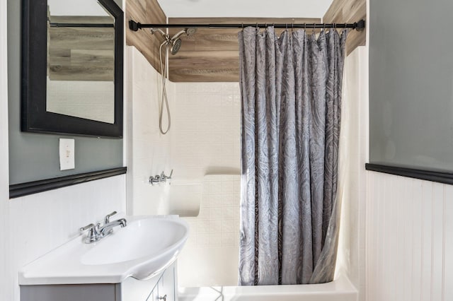 bathroom featuring vanity and shower / bathtub combination with curtain