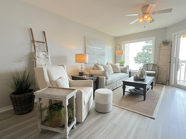 living room featuring ceiling fan and light hardwood / wood-style flooring