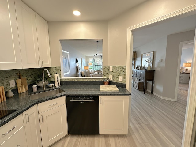 kitchen with white cabinetry, sink, decorative backsplash, black appliances, and light hardwood / wood-style flooring