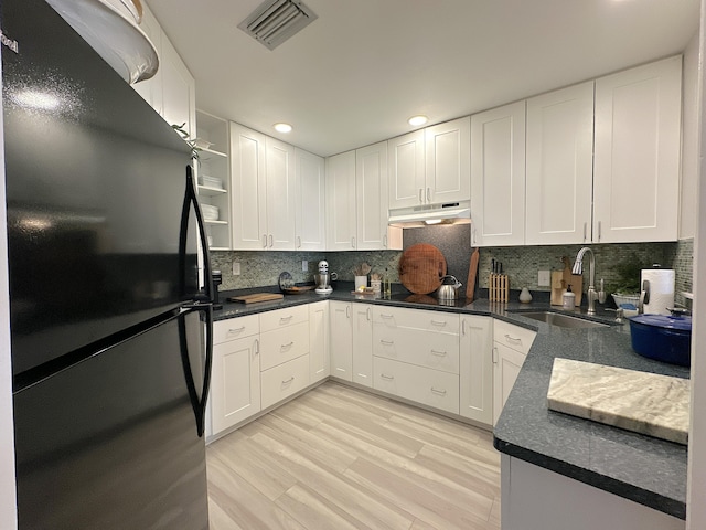 kitchen with white cabinetry, light wood-type flooring, sink, and black appliances