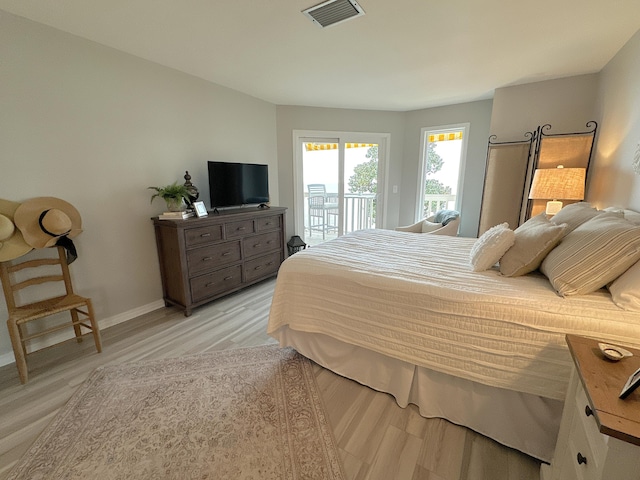 bedroom featuring light hardwood / wood-style flooring and access to outside