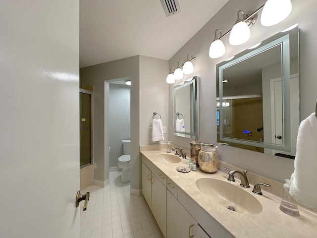 full bathroom with tile patterned flooring, vanity, enclosed tub / shower combo, and toilet