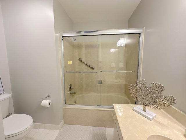 full bathroom featuring shower / bath combination with glass door, vanity, toilet, and tile patterned flooring