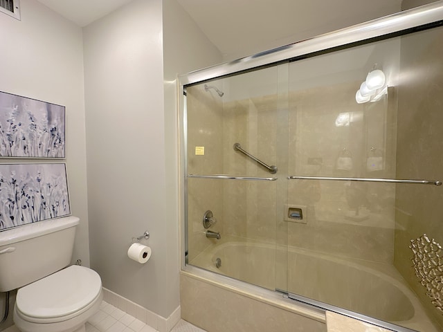 bathroom featuring toilet, tile patterned flooring, and combined bath / shower with glass door