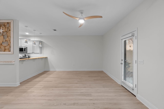 interior space featuring ceiling fan and light hardwood / wood-style floors