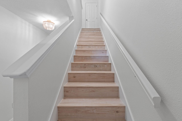 staircase with wood-type flooring