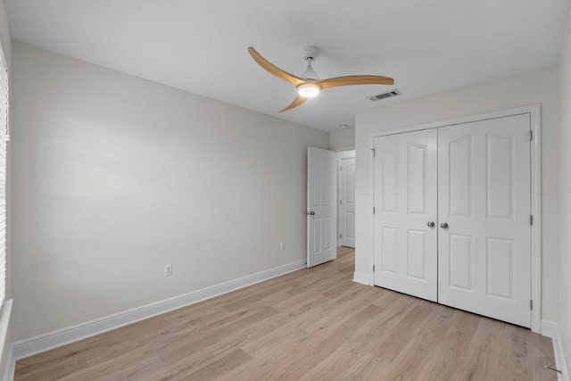 unfurnished bedroom with a closet, ceiling fan, and light wood-type flooring