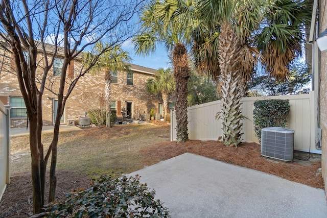 view of yard with central AC unit and a patio