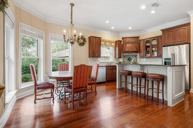 interior space featuring stainless steel appliances, tasteful backsplash, dark wood-type flooring, and sink