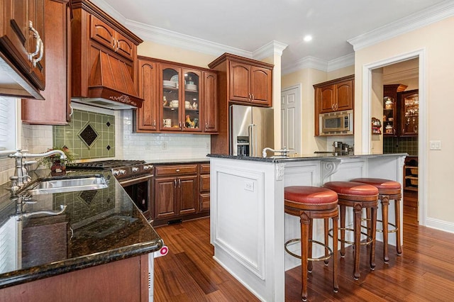 kitchen featuring sink, dark hardwood / wood-style floors, a kitchen island, and stainless steel appliances