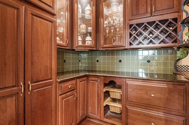 interior space with decorative backsplash and dark stone countertops