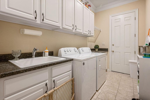 clothes washing area featuring cabinets, sink, ornamental molding, light tile patterned floors, and washer and clothes dryer