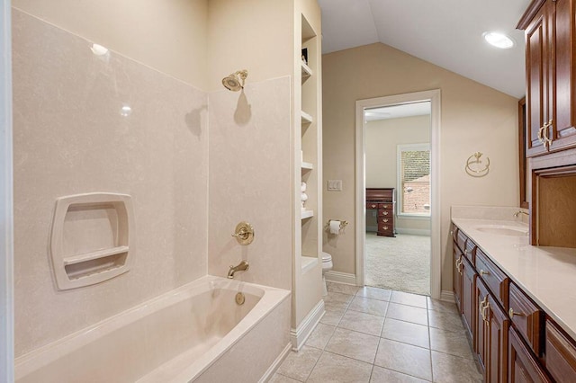 full bathroom with tile patterned flooring, toilet, washtub / shower combination, vaulted ceiling, and vanity