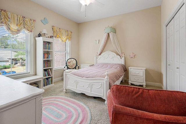 carpeted bedroom with a closet and ceiling fan