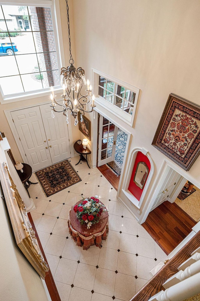 entrance foyer with tile patterned flooring and a towering ceiling