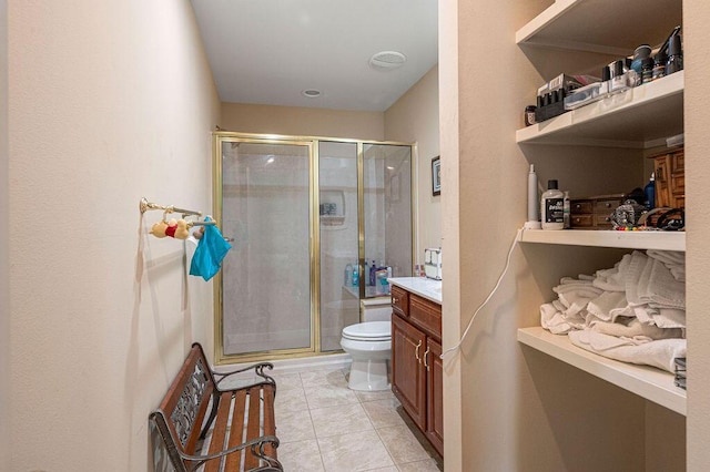 bathroom featuring vanity, toilet, tile patterned floors, and walk in shower