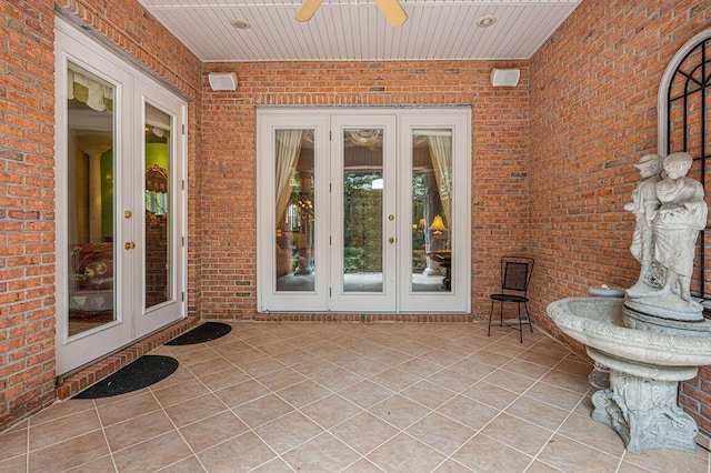 doorway to property with french doors, a patio, and ceiling fan