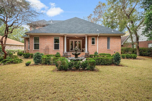 rear view of property with a yard