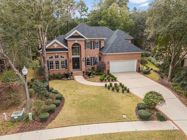 view of front of home featuring a garage and a front lawn