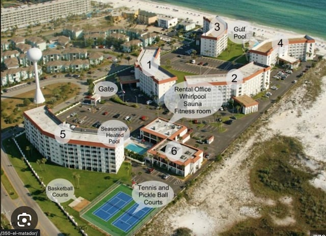 birds eye view of property with a view of city, a view of the beach, and a water view