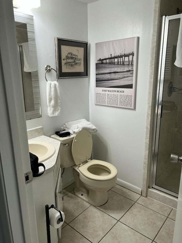 full bathroom with tile patterned flooring, baseboards, toilet, a stall shower, and vanity