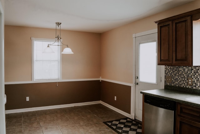 kitchen with dishwasher, hanging light fixtures, dark brown cabinets, tasteful backsplash, and dark tile patterned flooring