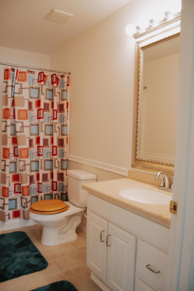 bathroom with walk in shower, tile patterned floors, toilet, and vanity