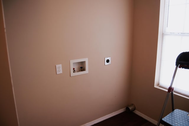 clothes washing area with electric dryer hookup, hookup for a washing machine, and dark hardwood / wood-style floors