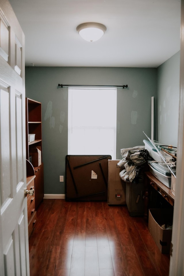 interior space featuring a barn door and dark hardwood / wood-style flooring