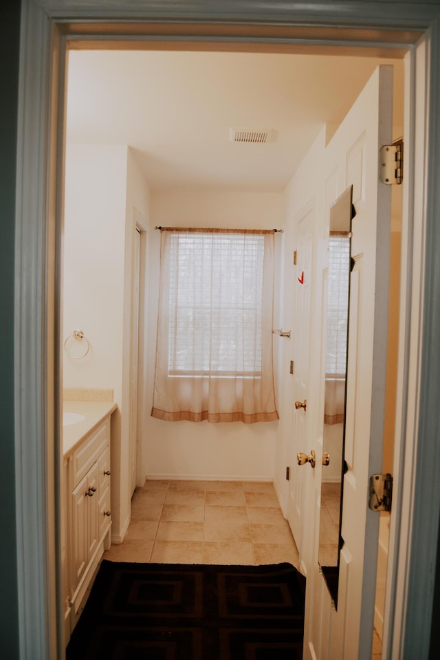 bathroom featuring tile patterned floors and vanity