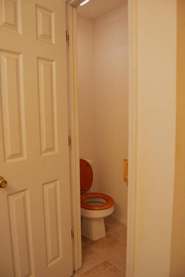 bathroom with tile patterned flooring and toilet