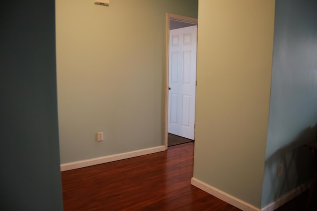 spare room featuring dark wood-type flooring