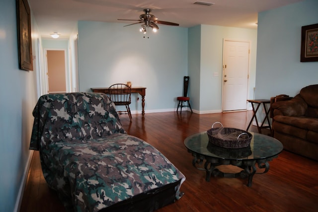 living room featuring dark hardwood / wood-style floors and ceiling fan