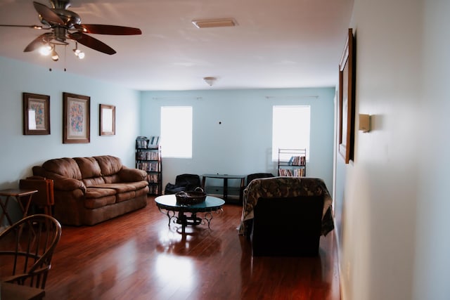 living room with dark hardwood / wood-style floors and ceiling fan