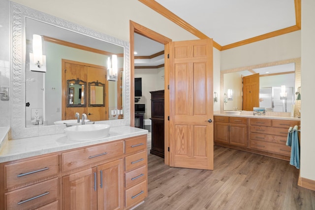 bathroom with vanity, wood-type flooring, and ornamental molding