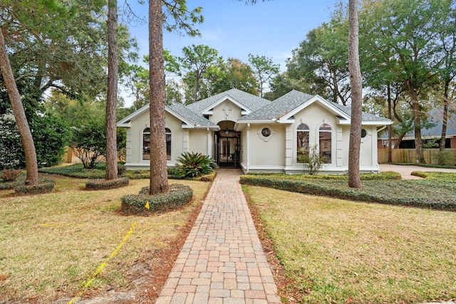 ranch-style house featuring french doors and a front yard