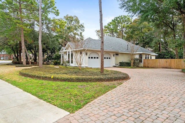 view of front of property featuring a garage and a front lawn