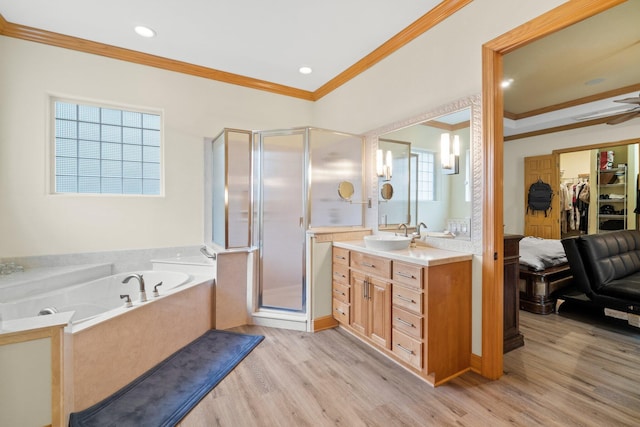 bathroom featuring vanity, hardwood / wood-style floors, ornamental molding, and separate shower and tub