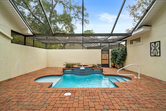 view of pool with an in ground hot tub, a lanai, and a patio area