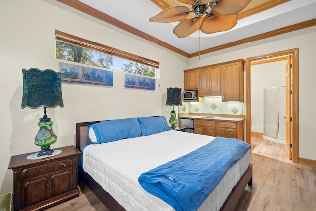 bedroom with sink, crown molding, and light wood-type flooring