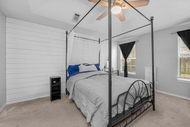 1775 Village Pkwy, Gulf Breeze, FL 32563 - bedroom with ceiling fan, light colored carpet, and wood walls