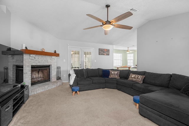 1775 Village Pkwy, Gulf Breeze, FL 32563 - living room with french doors, lofted ceiling, ceiling fan, a fireplace, and carpet