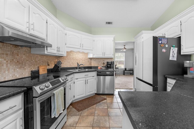 1775 Village Pkwy, Gulf Breeze, FL 32563 - kitchen with appliances with stainless steel finishes, sink, white cabinets, and decorative backsplash