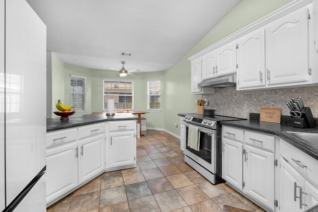 1775 Village Pkwy, Gulf Breeze, FL 32563 - kitchen with stainless steel electric stove, tasteful backsplash, white cabinetry, ceiling fan, and kitchen peninsula