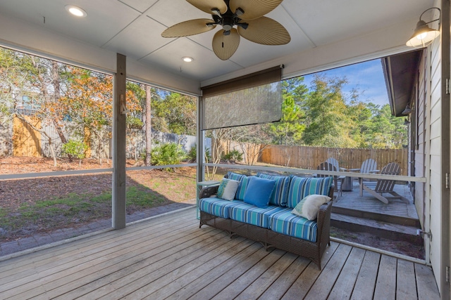 sunroom featuring ceiling fan