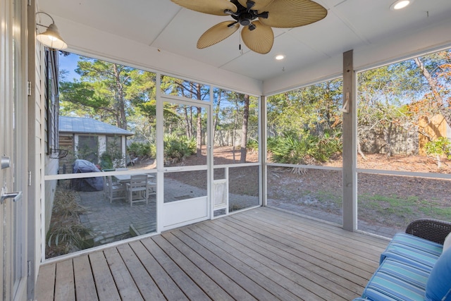 unfurnished sunroom featuring plenty of natural light and ceiling fan