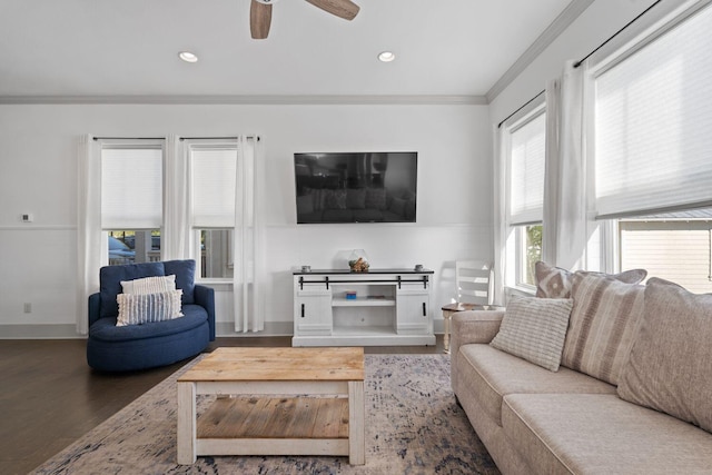 living room featuring hardwood / wood-style flooring, ornamental molding, and ceiling fan