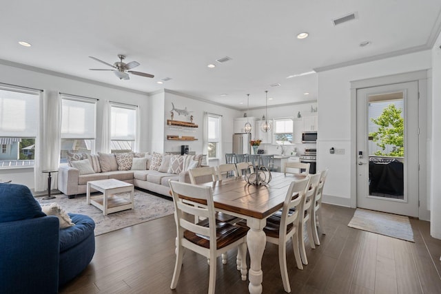 dining area with dark hardwood / wood-style flooring, sink, crown molding, and ceiling fan