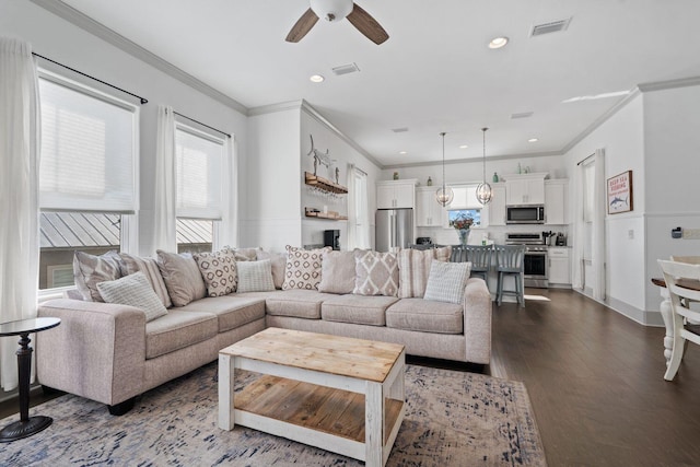 living room with dark hardwood / wood-style flooring, ornamental molding, and ceiling fan