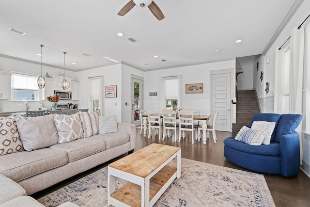 living room featuring ornamental molding, dark hardwood / wood-style floors, and ceiling fan